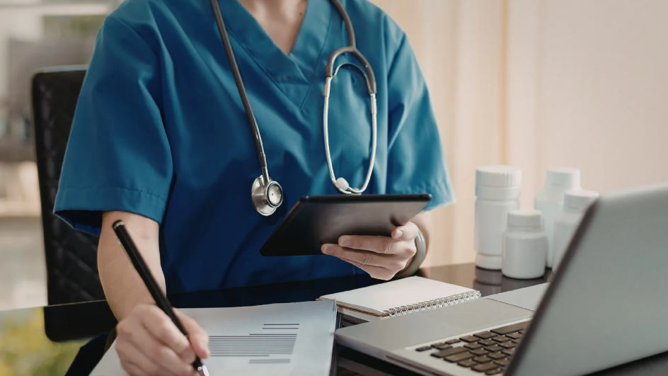 Hospital nursing director reviewing mentoring program documentation on tablet | Creative Health Care Insight