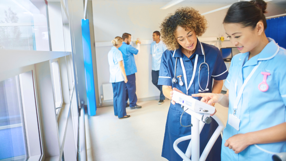 New graduate nurse receiving guidance from experienced mentor in hospital setting | Creative Health Care Insight