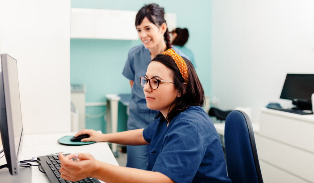 Clinical educator reviewing healthcare competency management data with nursing staff | CHCI