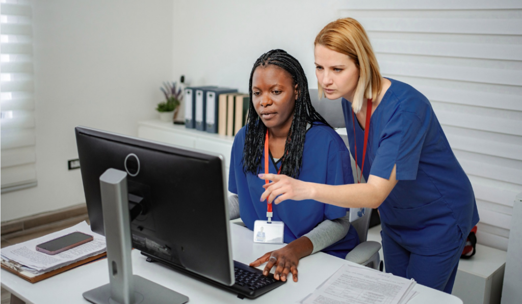 Healthcare educator reviewing competency-based orientation progress with newly hired nurse | CHCI