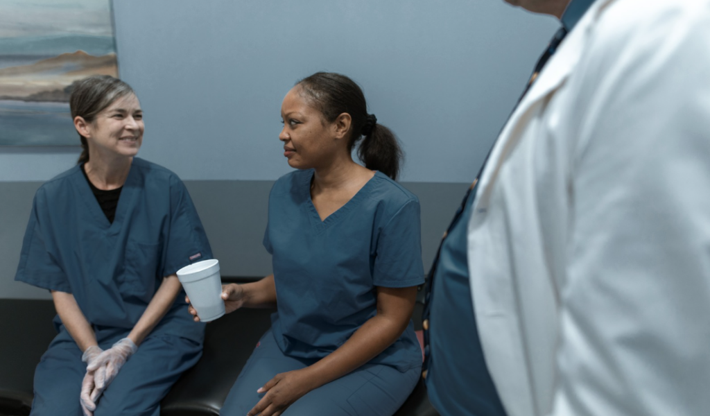 Hospital nurse speaking with a supportive healthcare leader about reducing nurse burnout | CHCI