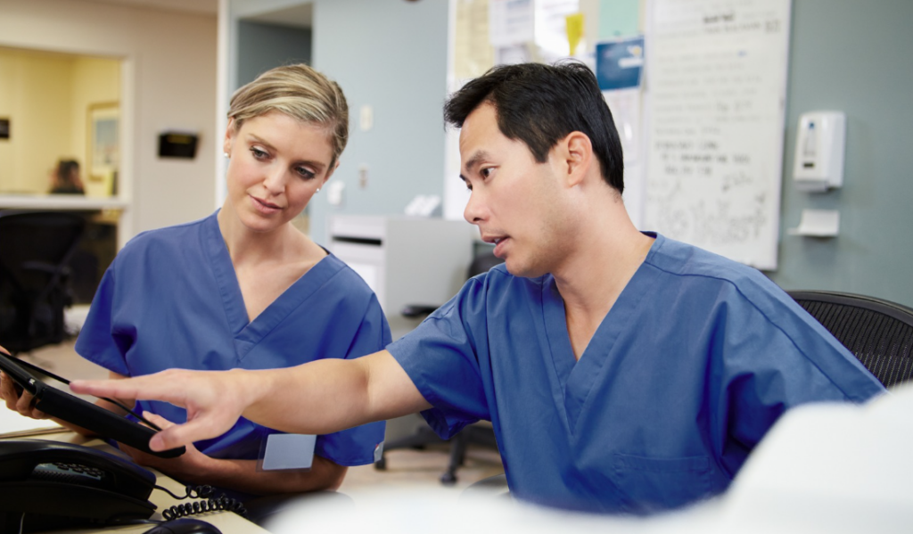 Preceptor and orientee discussing competency progress during a clinical orientation check-in | Creative Health Care Insight
