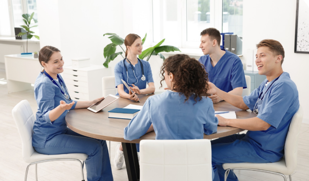 Nurse facilitating a healthcare team discussion about practice improvement | Creative Health Care Insight